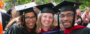 Image: Three smiling graduates at convocation