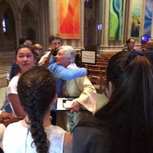 The Rev. Gina Campbell hugging young people at her farewell service at the Washington National Catherdral